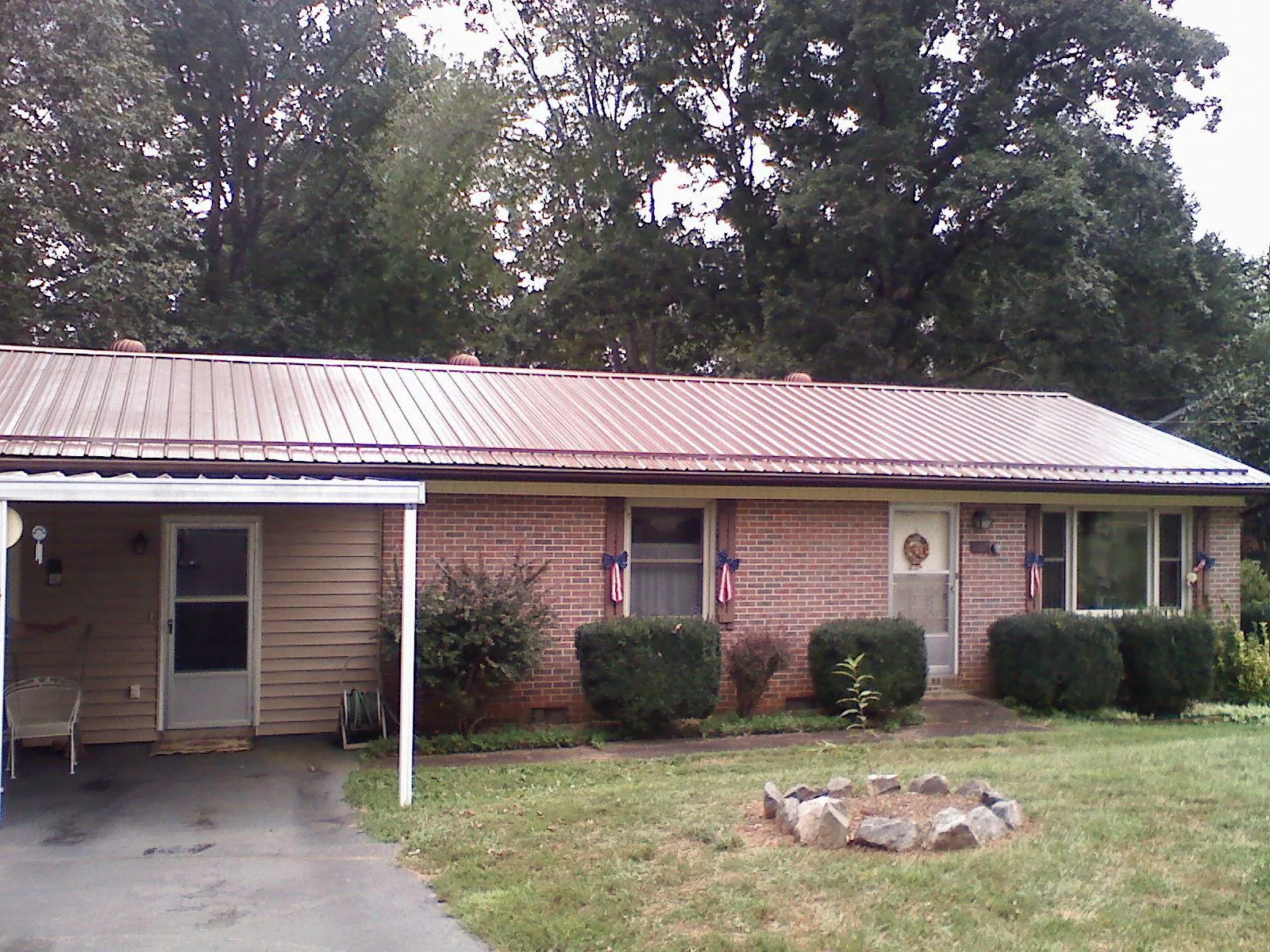 Bronze metal roof and carport on a brick ranch home — Roof Repair work by our crew in Littlestown