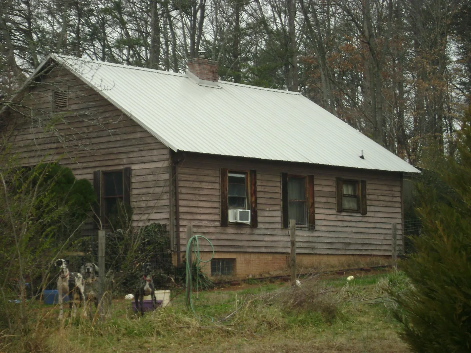 White metal roof on an old wood sided farmhouse, from a Metal Roof Installation job in Littlestown